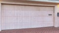 Pano Attached garage of San Dego California home with white door and brick driveway Royalty Free Stock Photo