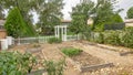 Pano Backyard of a property with a garden in it and a white fence. Royalty Free Stock Photo