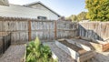 Pano Backyard with raised bed garden and wooden fence and gate Royalty Free Stock Photo