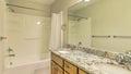 Pano Bathroom with double sink on marble countertop with cabinets and huge mirror Royalty Free Stock Photo