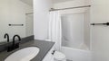 Pano Bathroom interior with black fixtures and one piece shower tub with white shower curtain Royalty Free Stock Photo