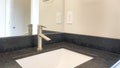 Pano Bathroom sink with granite countertop and single faucet Royalty Free Stock Photo