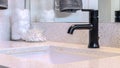 Pano Black faucet and single ceramic sink on the clean bathroom vanity of a home