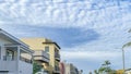 Pano Blue sky and puffy clouds in coastal neighborhood of Huntington Beach California Royalty Free Stock Photo