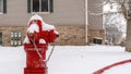 Pano Bright red fire hydrant on the roadside of community covered with snow in winter Royalty Free Stock Photo