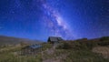 Pano Building of a house with glass greenhouse in the middle of a shrubland under the vibrant night sky Royalty Free Stock Photo