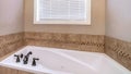 Pano Built in bathtub and shower stall inside bathroom of home with brown tiles Royalty Free Stock Photo