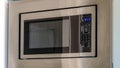 Pano Close up view of modern electric microwave oven inside the kitchen of a home Royalty Free Stock Photo