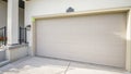 Pano Exterior of a house with closed garage door and part of a porch entry with stairs