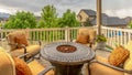 Pano frame Balcony with chairs around table with fire pit against homes and mountain view