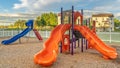Pano frame Bright orange and blue slides at a colorful fun playground for children