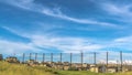 Pano frame Golf course fence with homes and snow capped mountain in the scenic background Royalty Free Stock Photo