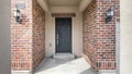 Pano Front door entrance exterior in the middle of red brick walls