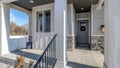 Pano Front view of a lovely home with stairs and porch in front of gray front door