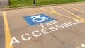 Pano Handicapped parking lot with painted handicap symbol and Van Accessible sign Royalty Free Stock Photo