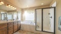Pano Home bathroom interior with bathtub shower stall and double sink vanity unit Royalty Free Stock Photo