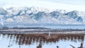 Pano House exterior with bay window against lake and mountain scenery in winter