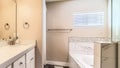 Pano Interior of clean residential bathroom with bathtub and double sink vanity area Royalty Free Stock Photo