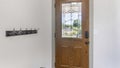 Pano Interior of a front door with wall rail-mounted hanging hooks