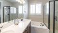 Pano Interior of a master bathroom with double vanity sink and windows Royalty Free Stock Photo