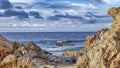 Pano Laguna Beach California shore with rocks and sand against ocean and cloudy sky Royalty Free Stock Photo