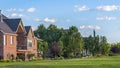 Pano Luxury houses and golf course with mountain and blue sky in the background Royalty Free Stock Photo