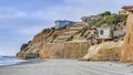 Pano Mountain houses overlooking ocean and beach with cloud and sky background Royalty Free Stock Photo