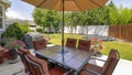 Pano Patio at a home backyard with trampoline and playground on the vibrant lawn
