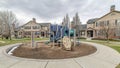 Pano Playground in the neighborhood park surorunded by houses and circular pathway Royalty Free Stock Photo