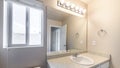 Pano Powder room with window and wall bulb lights over the single vanity sink