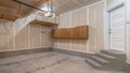 Pano Residential garage interior under construction with unfinished wall and floor Royalty Free Stock Photo