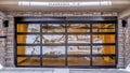 Pano Residential home with glass paned garage door and clearance sign below balcony Royalty Free Stock Photo