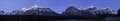 Panorama of Rocky Mountains in the moonlight along beautiful river