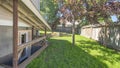 Pano Separate basement apartment entrance with stairs, glass panel and trees on the lawn at the side