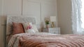 Pano Single bed with decorative headboard and feminine blankets inside a home bedroom