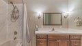 Pano Sink over cabinets and built in bathtub with shower inside bathroom of a home Royalty Free Stock Photo