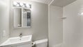 Pano Small all white bathroom interior with vanity sink and mirror Royalty Free Stock Photo