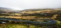 Pano of Steep and squiggly gravel road towards the fjords of Mjoifjordur