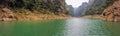 pano view of beautiful river between the mountains with a touring boat in the far end
