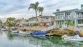 Pano Waterfront houses with view of stairs going down boat docks at a scenic canal