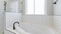 Pano White bathroom interior with window, drop in tub and shower stall