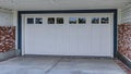 Pano White garage door under spacious balcony with white railing in San Diego CA