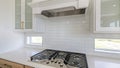 Pano White kitchen counter with built-in gas cooktop with griddle in stainless steel