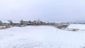 Pano White snowy view of a town with large houses covered in snow