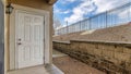Pano White wooden entrance door and glass sliding door at the exterior of house