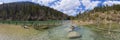 Panoram of small plansee with tree stumps in shallow water