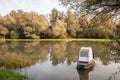 Panorama of an abandoned rowing boat, an blue small boat, resting in the neglected shore of the tamis timis river in Jabuka, in Royalty Free Stock Photo