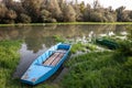 Panorama of an abandoned rowing boat, an blue small boat, resting in the neglected shore of the tamis timis river in Jabuka, in Royalty Free Stock Photo