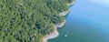 Aerial trees and cliff rock wall crystal water at Lake Travis, A