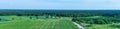 Panorama from aerial photographs of arable land and meadows with a large forest area in the background, drone shot Royalty Free Stock Photo